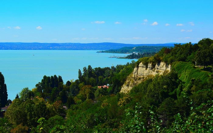 Lake Balaton with a cliffside covered in trees