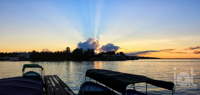 Sunset over water with boats docked at Isla Colon, Panama