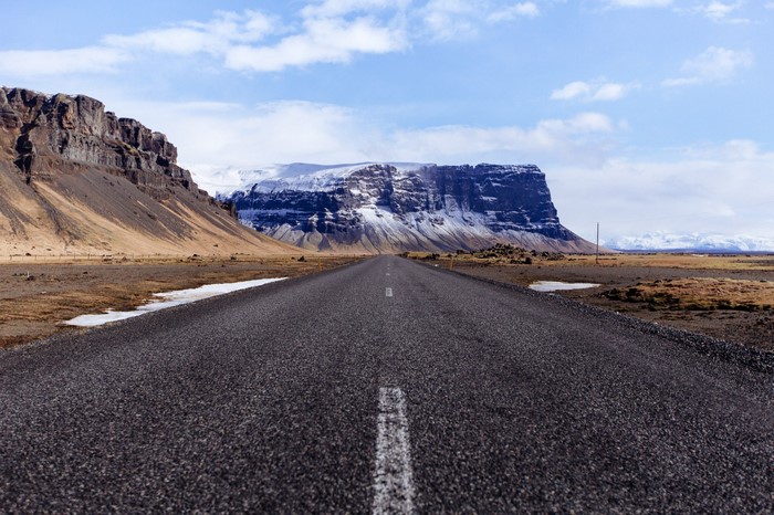 Road leading to a snow-capped mountain plateau