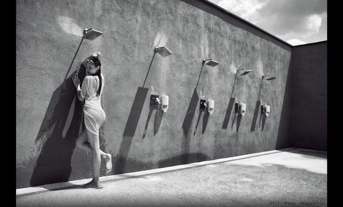 Woman showering outdoors in black and white