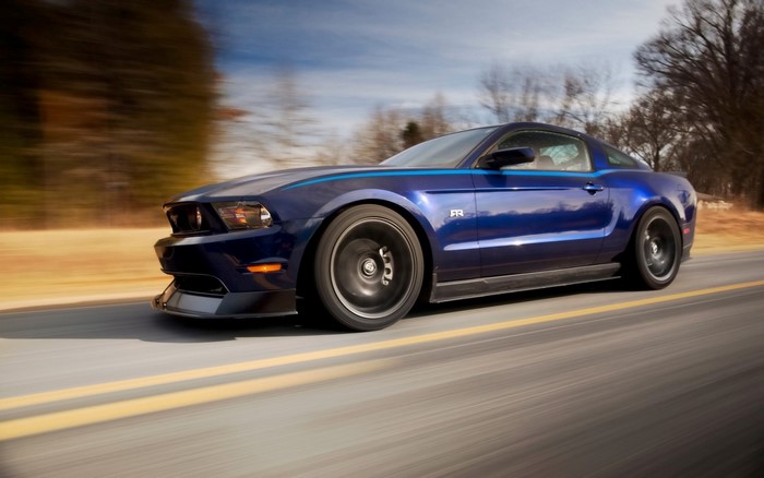 Blue Ford Mustang RTR driving on a road