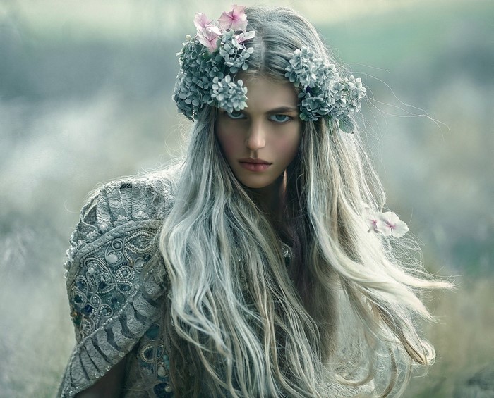 Woman with flower crown and ornate jacket