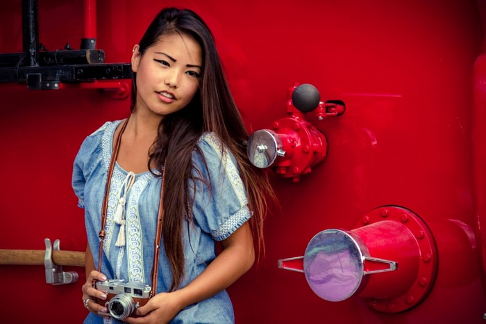 Woman with camera in front of red fire truck