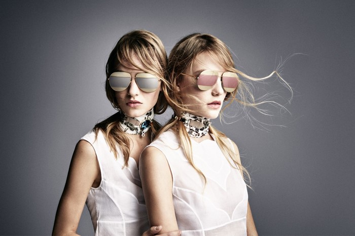 Two women wearing sunglasses and scarves