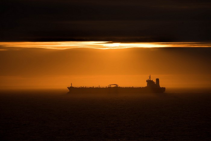 Ship sailing on the ocean during sunset