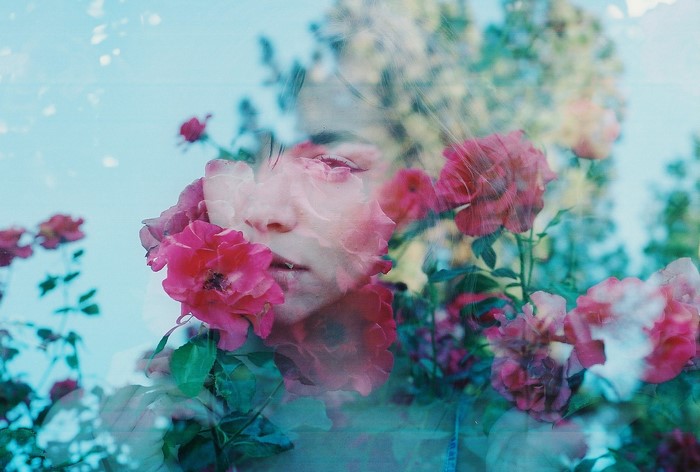 Double exposure of a woman and pink roses