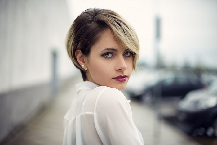 Woman with short blonde and brown hair looking at viewer