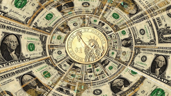 US Dollar Bills and Coin in Circular Pattern