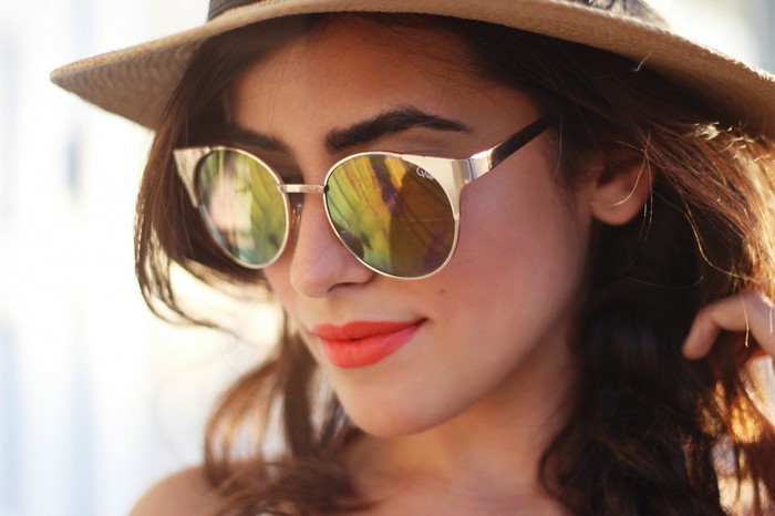 Woman wearing sunglasses and a hat