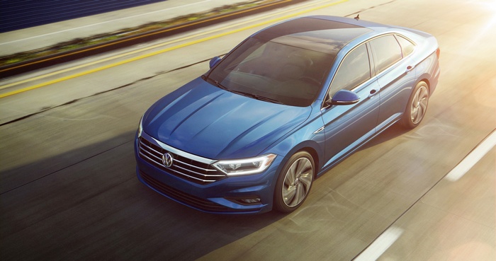 Blue 2018 Volkswagen Jetta driving on a highway