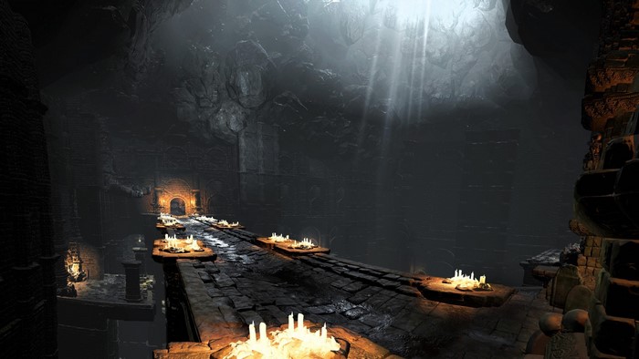 Dark Souls III screenshot of a dark cave with candles