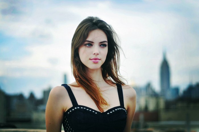 Model Veronica Zoppolo in black dress with city background