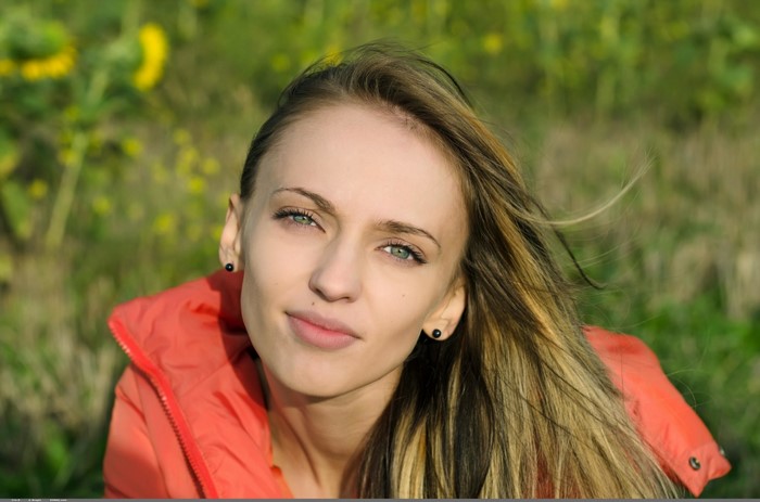 Woman with long brown hair and green eyes