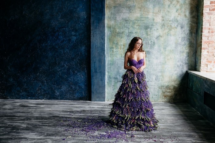 Woman in a strapless dress made of purple flowers