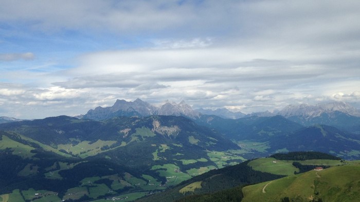 Mountain range in Austria with green hills and clouds