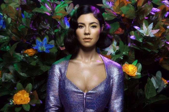 Marina Diamandis in a sparkly purple dress with flowers