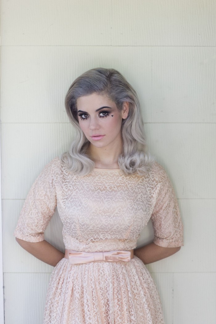 Woman with grey hair in a pink lace dress