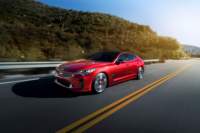 Red 2018 Kia Stinger driving on a road