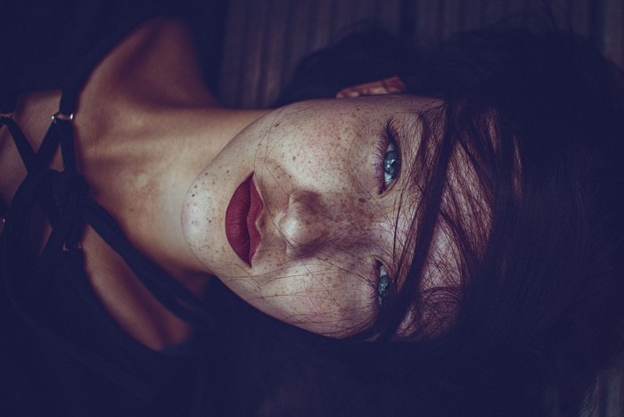 Close up of a woman with freckles and blue eyes