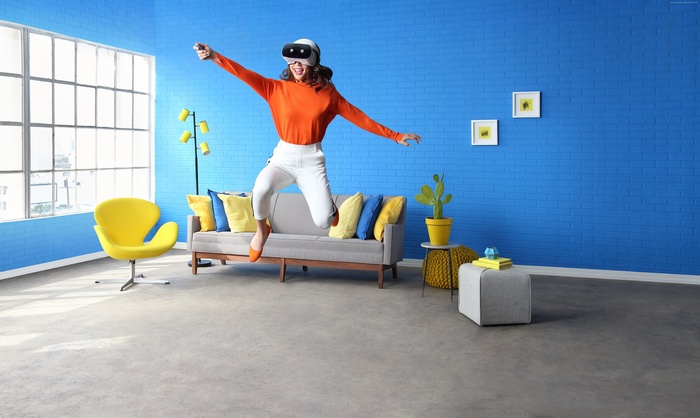 Woman jumping with Lenovo Mirage Solo VR headset