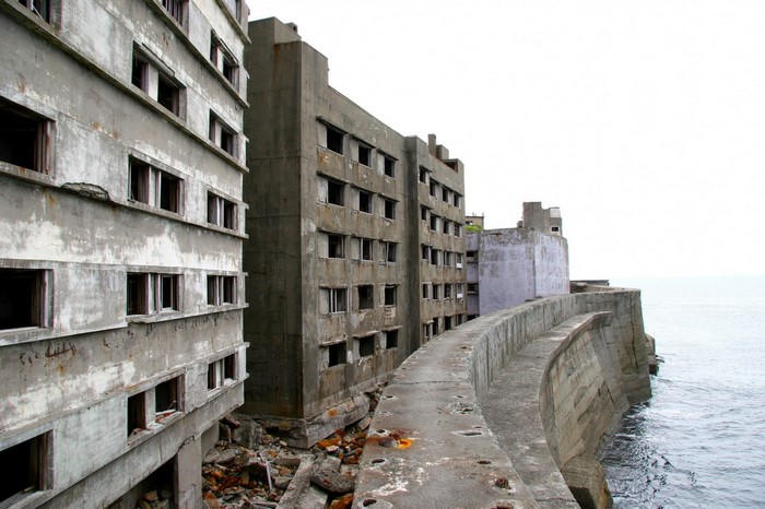Ruined concrete buildings on Hashima Island by the sea
