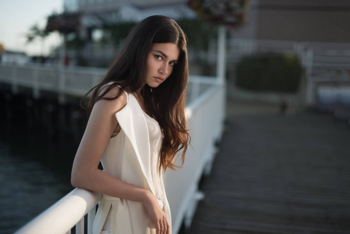 Woman in white clothing on a pier