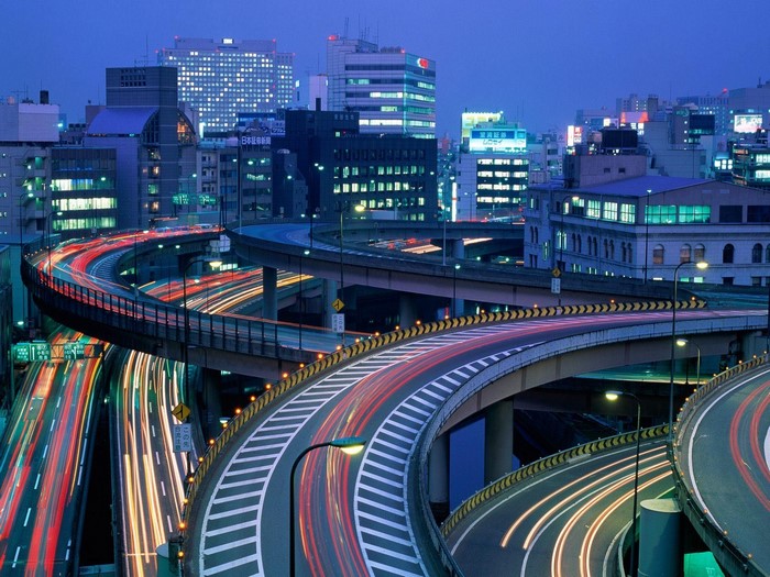 Cityscape with highway interchange at night