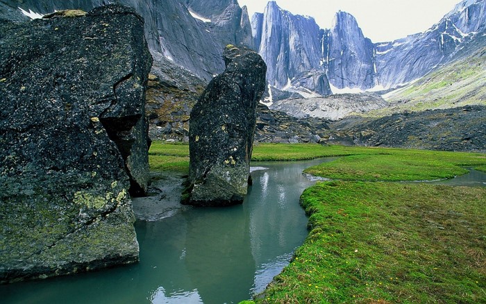 Jagged mountains and a winding creek in a rocky valley