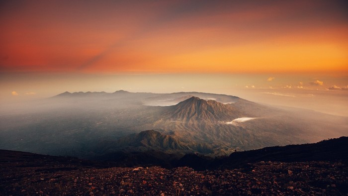 Mountain range at sunset with mist