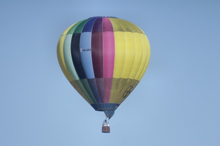 Hot air balloon with colorful panels flying in the sky