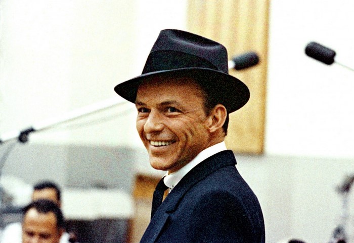 Frank Sinatra wearing a fedora and suit