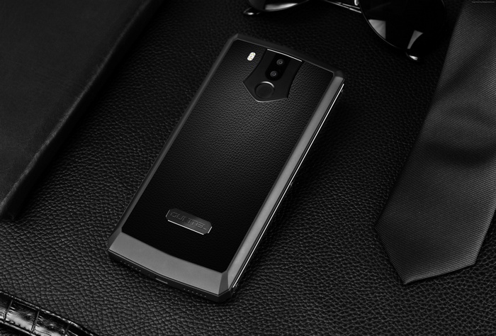 OUKITEL K10 smartphone on a black textured surface