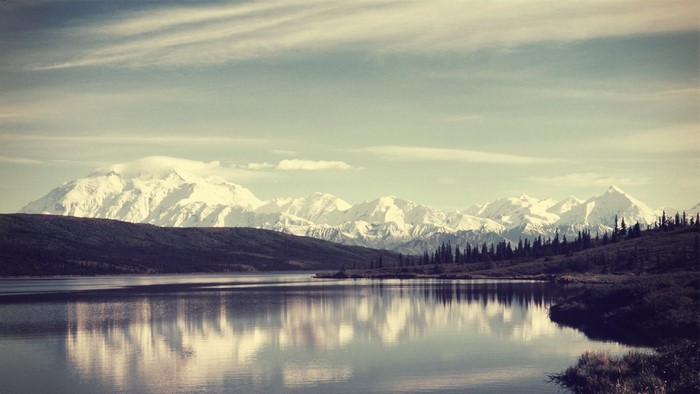Snow-capped mountains reflected in a lake