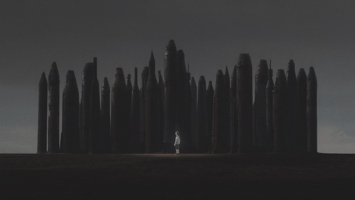 Child standing in a dark forest of stone pillars