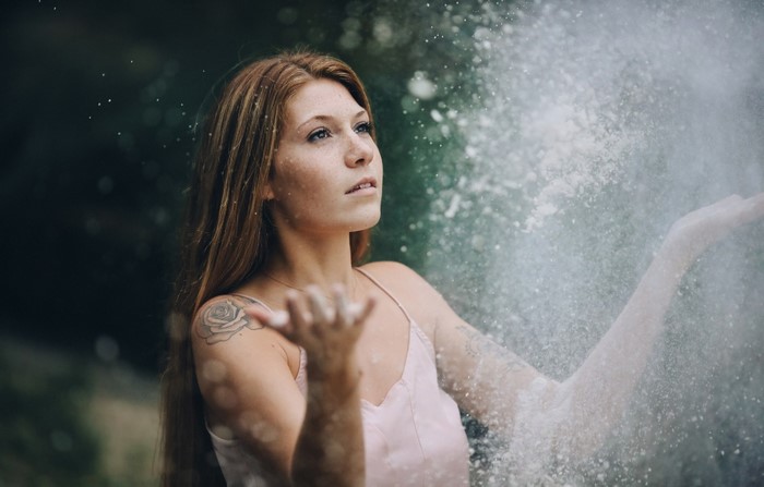 Woman with red hair throwing powder