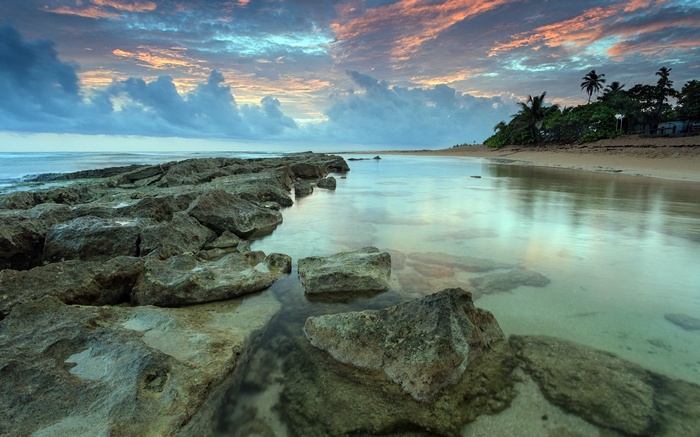 Rocky coastline at sunset with colorful clouds