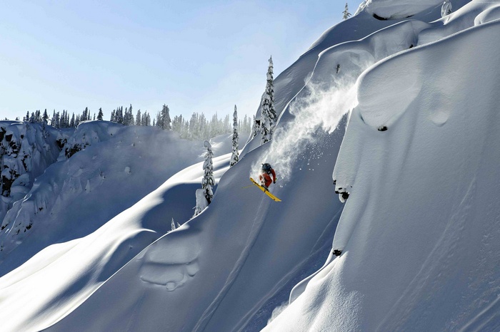 Skier jumping off a snowy mountain in Haines, Alaska