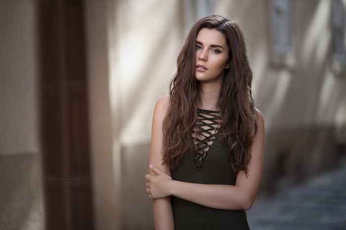 Woman with long brown hair in a dark dress