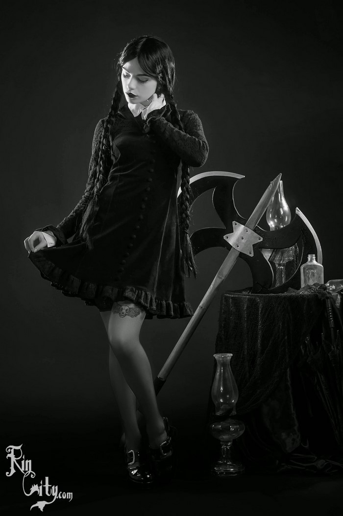 Wednesday Addams cosplay with axe