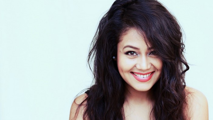 Neha Kakkar smiling with long dark hair