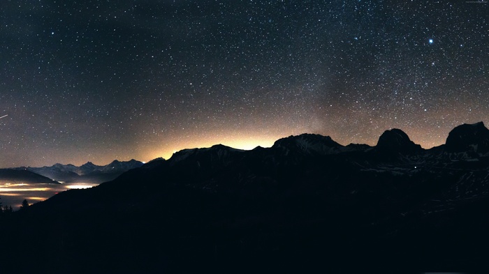 Mountains under a starry night sky