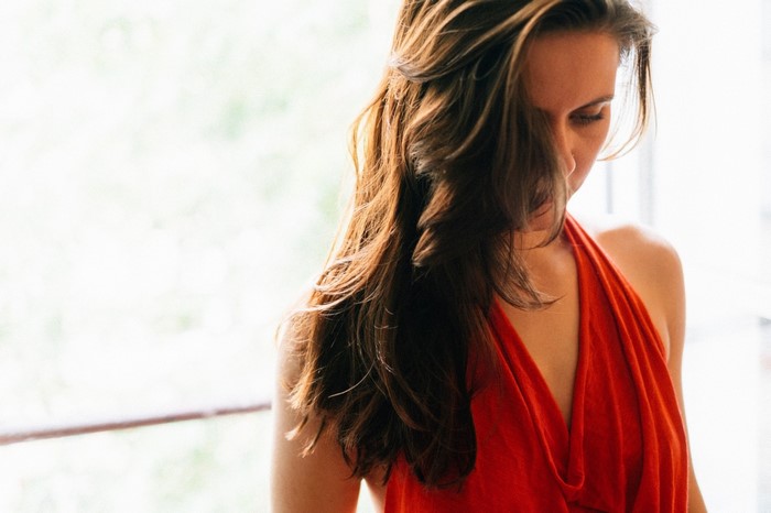 Woman with long brown hair in a red dress