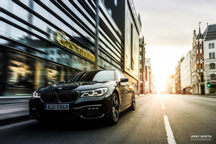 Black BMW Sedan driving on a street in Riga, Latvia