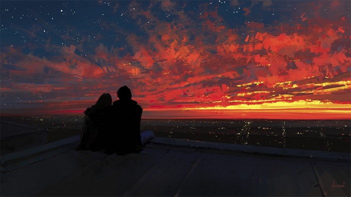 Couple watching a vibrant sunset over a city