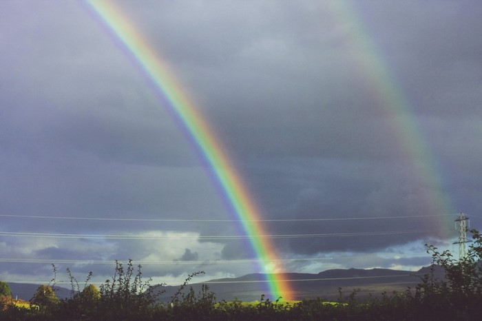 Double rainbow over a cloudy sky