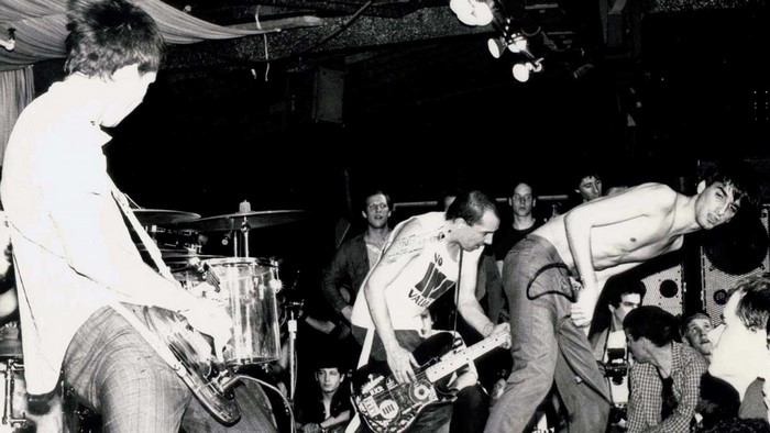 Band performing live music on stage with audience