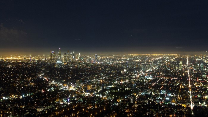 Nighttime panorama of a sprawling city skyline