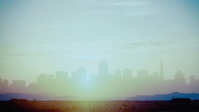 City skyline at sunrise with haze