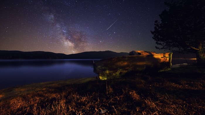 Boat under the Milky Way at night