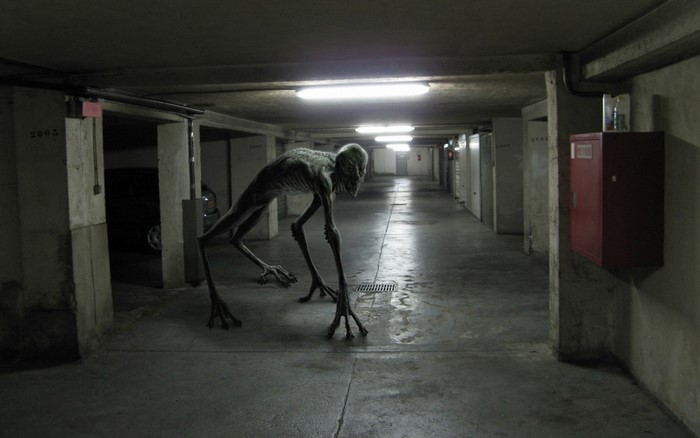 Alien creature in a dark parking garage